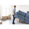 side view man handling couch while preparing move out